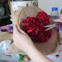 picture of student making rag rug heart 