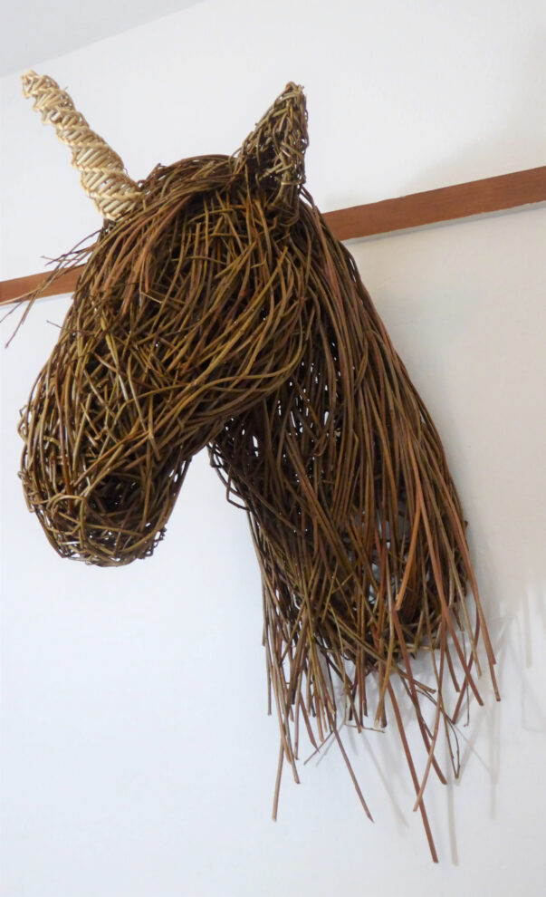 willow unicorn head sculpture on wall 
